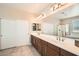 Bright bathroom features dual sinks, spacious countertop and ample storage with enclosed shower and tub at 1113 Via Della Costrella, Henderson, NV 89011