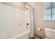 Bright bathroom featuring a shower-tub combo and natural light at 1113 Via Della Costrella, Henderson, NV 89011