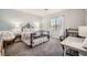 Cozy bedroom with a decorative iron bed frame, desk and natural light at 1113 Via Della Costrella, Henderson, NV 89011