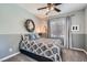 Comfortable bedroom with a patterned comforter, decorative wreath, and neutral gray tones at 1113 Via Della Costrella, Henderson, NV 89011