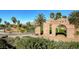 Tuscany Golf Club entrance with stone pillars, palm trees, and lush landscaping at 1113 Via Della Costrella, Henderson, NV 89011