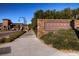 Tuscany Village and Golf entrance sign with brick pillars, landscaping, and decorative lighting at 1113 Via Della Costrella, Henderson, NV 89011