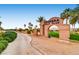 The Chimera Golf Club entrance sign with desert landscaping and palm trees on a clear day at 1113 Via Della Costrella, Henderson, NV 89011