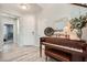 Bright entryway with a piano, white door and stylish flooring, creating a welcoming and elegant first impression at 1113 Via Della Costrella, Henderson, NV 89011