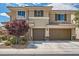 Charming two-story home featuring a two-car garage, stone accents, and a beautifully landscaped front yard at 1113 Via Della Costrella, Henderson, NV 89011