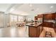 Open kitchen with stainless steel appliances, island, and adjacent dining area at 1113 Via Della Costrella, Henderson, NV 89011
