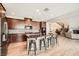 Modern kitchen featuring dark wood cabinetry, center island, and stainless appliances at 1113 Via Della Costrella, Henderson, NV 89011