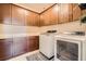 Convenient laundry room with front load washer, dryer, cabinets, and countertop space at 1113 Via Della Costrella, Henderson, NV 89011