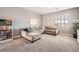 Comfortable living room with a sectional sofa, plush carpet and bright light at 1113 Via Della Costrella, Henderson, NV 89011