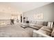 Bright living room with a sectional sofa, plush carpet and plenty of space at 1113 Via Della Costrella, Henderson, NV 89011