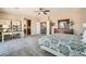 Inviting bedroom features dresser with vanity, connected desk, and doorway to bath at 1113 Via Della Costrella, Henderson, NV 89011