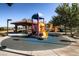 Community playground featuring a colorful slide and shaded picnic area for residents at 1113 Via Della Costrella, Henderson, NV 89011
