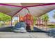 Colorful playground with climbing features, slide, and sun shade canopy for outdoor fun at 1113 Via Della Costrella, Henderson, NV 89011