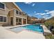 Beautiful in-ground pool and spa with custom stonework, tanning ledge, and outdoor living space at 1113 Via Della Costrella, Henderson, NV 89011