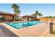 Resort-style pool featuring clear blue water, palm trees, and shaded cabana area at 1113 Via Della Costrella, Henderson, NV 89011