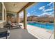 Relax in this backyard oasis, featuring a pool, spa, and lounge chairs for ultimate comfort at 1113 Via Della Costrella, Henderson, NV 89011