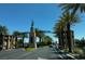 Entrance to Historic Downtown with palm trees and light traffic under a clear blue sky at 1126 Azul Way, Boulder City, NV 89005