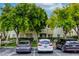 Exterior view of a condo building with assigned parking and green trees at 1420 Red Crest Ln # 202, Las Vegas, NV 89144