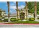 Charming building entrance framed by palm trees and lush landscaping at 1420 Red Crest Ln # 202, Las Vegas, NV 89144