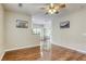 Open-concept living area with wood flooring, neutral walls, and a ceiling fan at 1420 Red Crest Ln # 202, Las Vegas, NV 89144