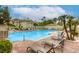 Luxurious community pool with seating, palm trees, and well-maintained landscaping at 1420 Red Crest Ln # 202, Las Vegas, NV 89144