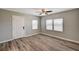 Bedroom showcasing wood-look flooring and a closet door with blinds on windows at 155 Magnesium St, Henderson, NV 89015