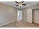 Bedroom featuring wood-look floors, a ceiling fan, and a sliding door closet at 155 Magnesium St, Henderson, NV 89015