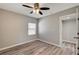 Spacious bedroom with neutral walls, ceiling fan, wood-look floors, and a window at 155 Magnesium St, Henderson, NV 89015