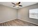 Bedroom featuring wood-look floors, neutral walls, and a window with blinds at 155 Magnesium St, Henderson, NV 89015