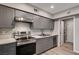 Updated kitchen features gray cabinetry, stainless steel appliances, and light countertops at 155 Magnesium St, Henderson, NV 89015