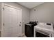 A laundry room showcases a modern black washing machine next to a white dryer at 155 Magnesium St, Henderson, NV 89015