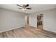 Living room with wood-look floors and an opening into an adjacent room at 155 Magnesium St, Henderson, NV 89015