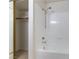 Bathroom featuring a shower-tub combination and a closet with shelves for organized storage at 1570 Jamielinn Ln # 104, Las Vegas, NV 89110
