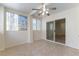 Bright bedroom with tile flooring, ceiling fan, and sliding glass door access to the backyard at 1570 Jamielinn Ln # 104, Las Vegas, NV 89110