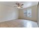 Well-lit bedroom with tile flooring, a ceiling fan, a window, and closet for organized storage at 1570 Jamielinn Ln # 104, Las Vegas, NV 89110