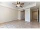 Bright bedroom featuring a ceiling fan, tile floors, and access to an ensuite bathroom and closet at 1570 Jamielinn Ln # 104, Las Vegas, NV 89110