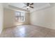 Bright bedroom with tile flooring, ceiling fan, and ample natural light at 1570 Jamielinn Ln # 104, Las Vegas, NV 89110