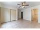 Bedroom featuring tile flooring, a ceiling fan, a closet, and a doorway to another room at 1570 Jamielinn Ln # 104, Las Vegas, NV 89110