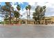 Community clubhouse framed by tall palm trees and beautifully maintained landscaping at 1570 Jamielinn Ln # 104, Las Vegas, NV 89110