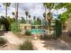 Fenced community pool surrounded by mature palm trees and landscaping at 1570 Jamielinn Ln # 104, Las Vegas, NV 89110