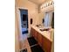 Bathroom with dual sinks, wood cabinets and a tub/shower combo, ensuring functionality at 1612 Lefty Garcia Way, Henderson, NV 89002