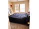 Bedroom with carpet and natural light coming through window, and small furniture items at 1612 Lefty Garcia Way, Henderson, NV 89002