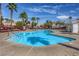 Community pool surrounded by palm trees, offering a perfect spot for relaxation and recreation at 1612 Lefty Garcia Way, Henderson, NV 89002