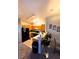 Well-lit kitchen featuring wood cabinets, a breakfast bar and a range of appliances at 1612 Lefty Garcia Way, Henderson, NV 89002