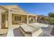 Backyard with covered patio, hot tub and desert landscaping features at 2105 Poppywood Ave, Henderson, NV 89012