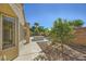 Desert landscaped backyard featuring a covered patio with a hot tub and view at 2105 Poppywood Ave, Henderson, NV 89012
