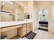 Well lit bathroom with a skylight and large vanity at 2105 Poppywood Ave, Henderson, NV 89012
