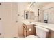 Well-lit bathroom featuring a vanity with framed mirror and shower-tub combination at 2105 Poppywood Ave, Henderson, NV 89012