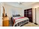 Bedroom featuring a large bed, plantation shutters on the windows, and wood shelving at 2105 Poppywood Ave, Henderson, NV 89012