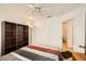 Bright bedroom featuring a ceiling fan, closet, and convenient access to the attached bathroom at 2105 Poppywood Ave, Henderson, NV 89012